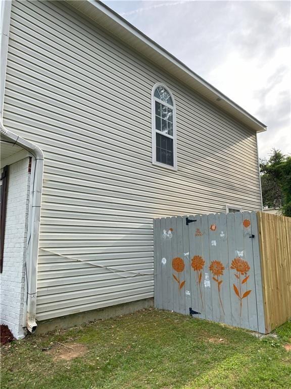 view of side of home featuring a lawn