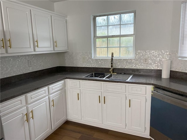 kitchen featuring stainless steel dishwasher, white cabinetry, sink, and dark wood-type flooring