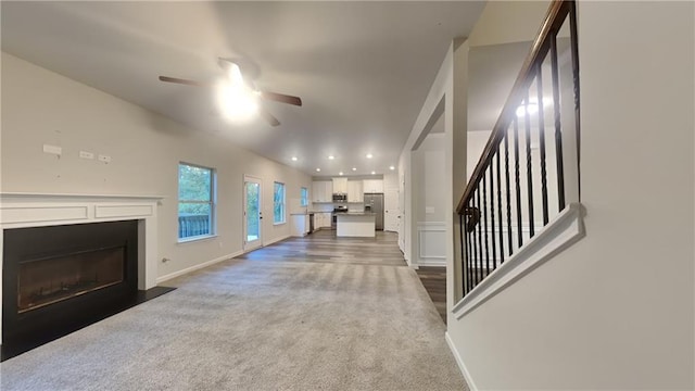 living room featuring carpet flooring and ceiling fan