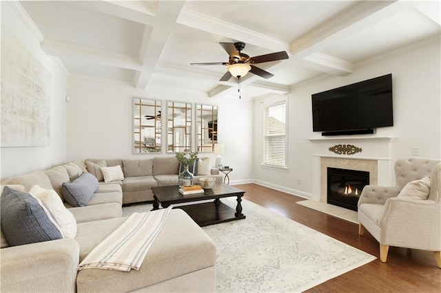 living room featuring beam ceiling, a fireplace with flush hearth, coffered ceiling, and wood finished floors