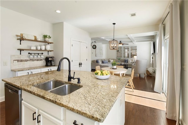 kitchen with visible vents, a sink, dark wood-type flooring, stainless steel dishwasher, and open floor plan