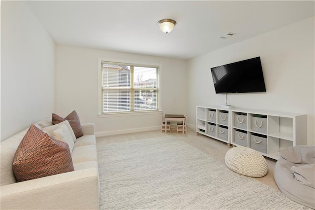 carpeted living room featuring baseboards and visible vents