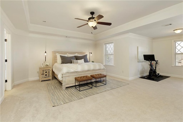 carpeted bedroom featuring a raised ceiling, crown molding, visible vents, and baseboards