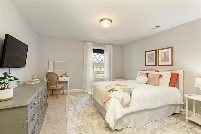 bedroom featuring light colored carpet, visible vents, and baseboards