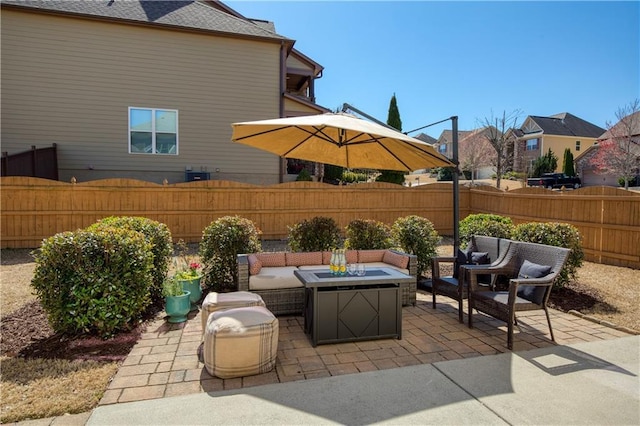 view of patio / terrace with an outdoor living space with a fire pit and a fenced backyard