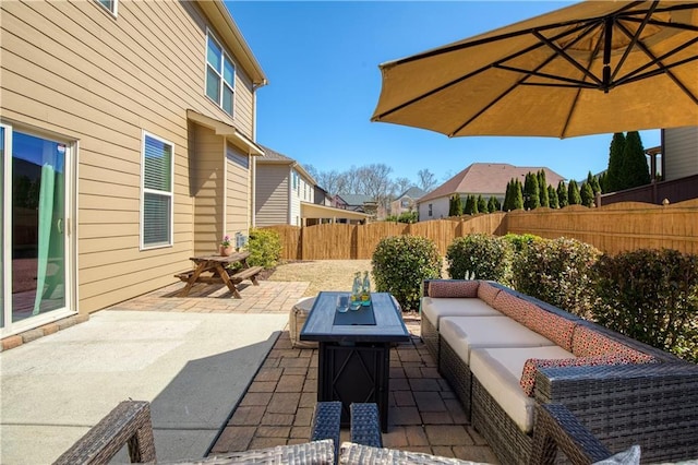 view of patio featuring an outdoor living space with a fire pit and a fenced backyard