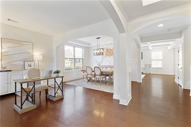 dining room with visible vents, a healthy amount of sunlight, and dark wood-style flooring