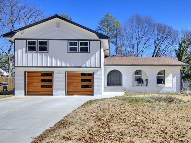 view of front facade featuring concrete driveway, brick siding, and an attached garage