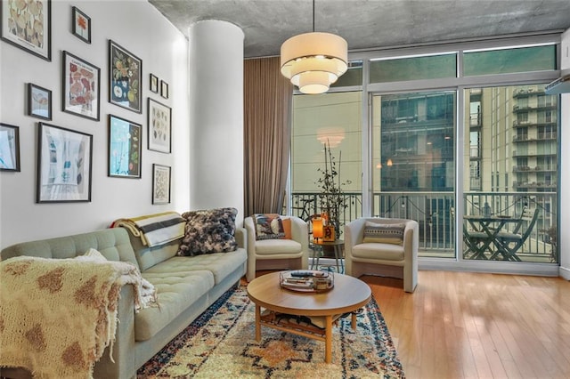 living room featuring floor to ceiling windows and hardwood / wood-style floors