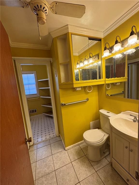 bathroom with crown molding, vanity, tile patterned floors, and toilet