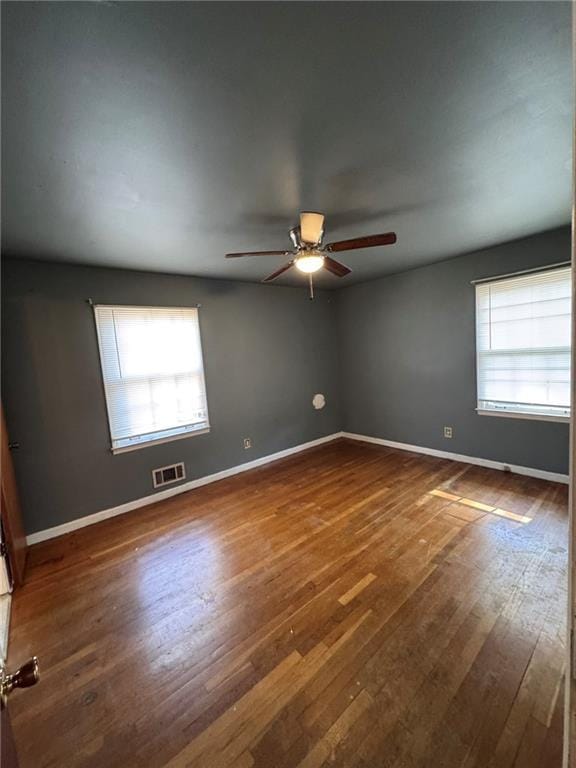 unfurnished room featuring ceiling fan and dark hardwood / wood-style flooring