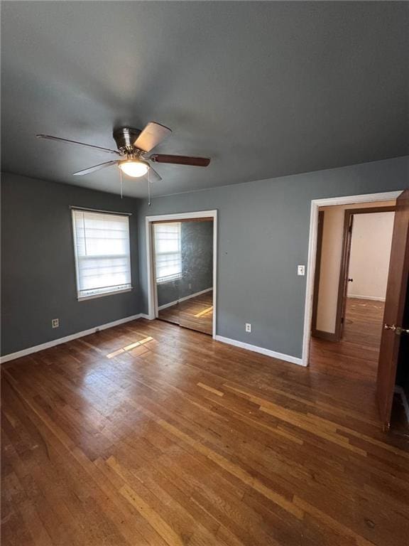 unfurnished room featuring ceiling fan and dark hardwood / wood-style floors