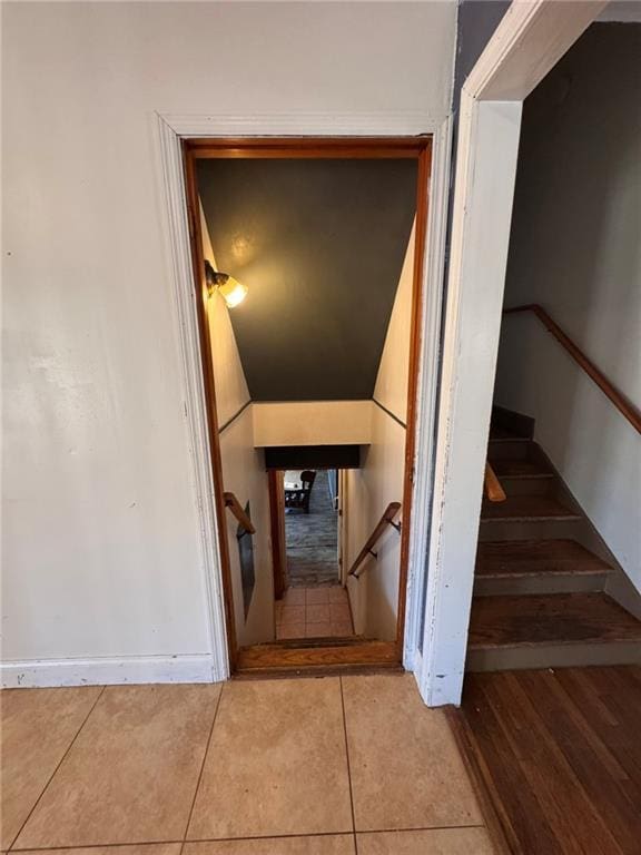 stairway featuring tile patterned flooring