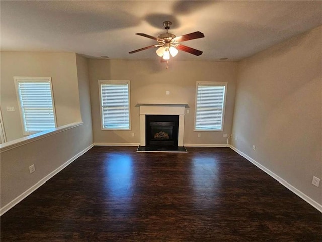 1021 Rock Elm Dr, Auburn, GA 30011 - unfurnished living room featuring wood finished floors, ceiling fan, baseboards, and a fireplace with raised hearth