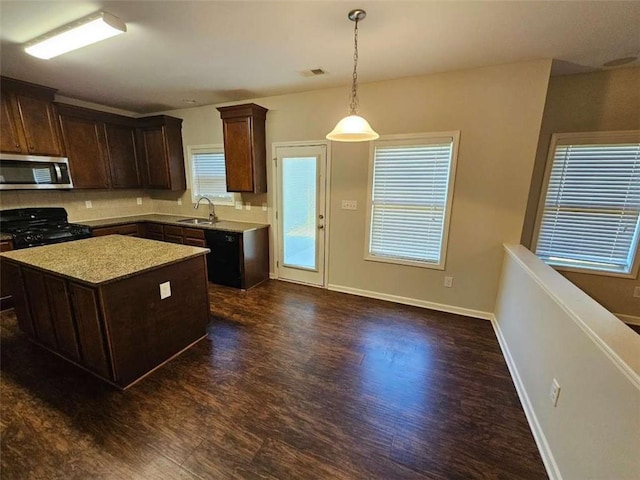 1021 Rock Elm Dr, Auburn, GA 30011 - kitchen featuring black appliances, a sink, dark wood-style floors, a center island, and dark brown cabinets