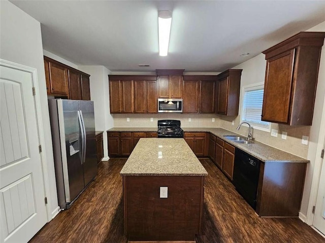 1021 Rock Elm Dr, Auburn, GA 30011 - kitchen featuring black appliances, a sink, a center island, dark wood-style floors, and decorative backsplash