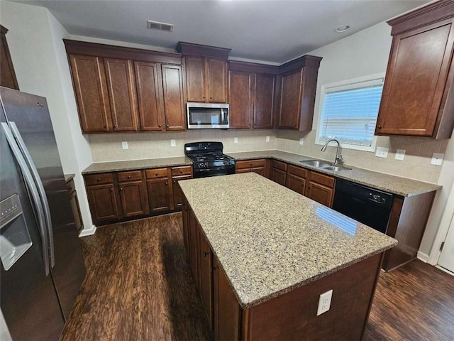 1021 Rock Elm Dr, Auburn, GA 30011 - kitchen with black appliances, a sink, dark wood finished floors, backsplash, and light stone countertops