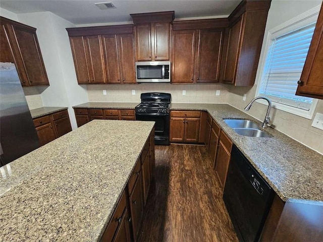 1021 Rock Elm Dr, Auburn, GA 30011 - kitchen with black appliances, a sink, dark wood-style floors, light stone countertops, and tasteful backsplash