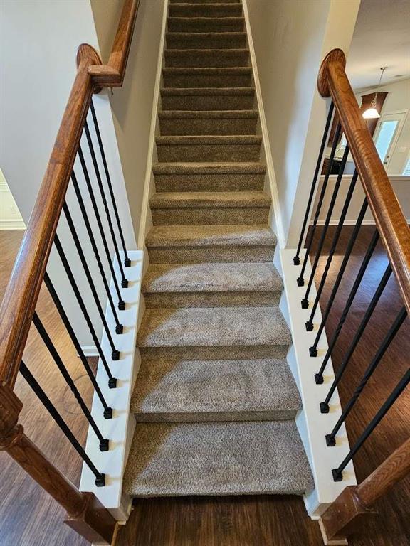 1021 Rock Elm Dr, Auburn, GA 30011 - stairway with wood finished floors and baseboards