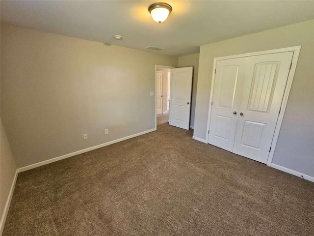 1021 Rock Elm Dr, Auburn, GA 30011 - unfurnished bedroom featuring dark carpet and baseboards