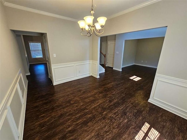 1021 Rock Elm Dr, Auburn, GA 30011 - unfurnished dining area featuring a chandelier, ornamental molding, a decorative wall, dark wood-style flooring, and wainscoting