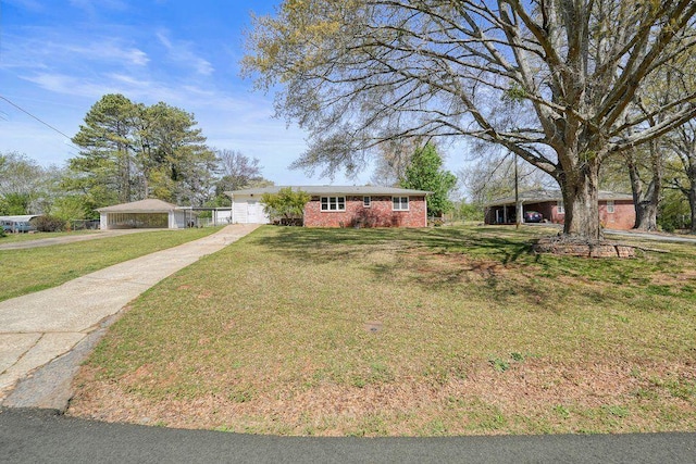 ranch-style house with a front lawn, driveway, an attached garage, and brick siding