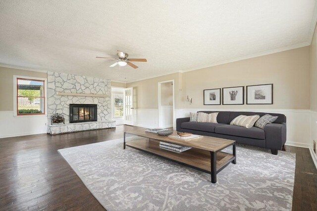 living room featuring a wainscoted wall, a wealth of natural light, and ceiling fan