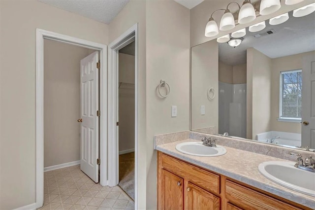 bathroom with vanity, independent shower and bath, and a textured ceiling