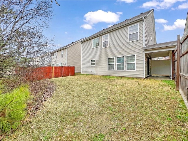 rear view of property featuring a yard