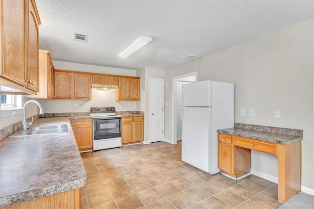 kitchen featuring sink, a textured ceiling, and white appliances