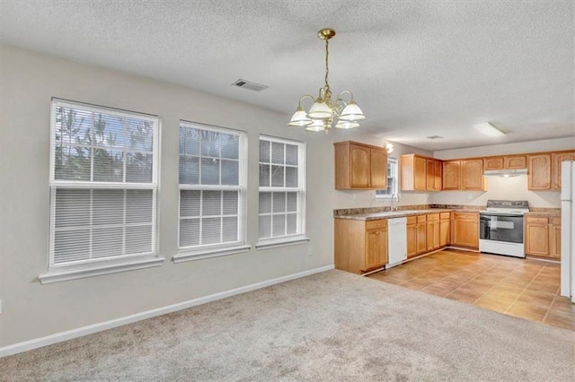 kitchen featuring light brown cabinetry, decorative light fixtures, a chandelier, light carpet, and white appliances