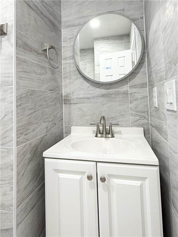 bathroom with tile walls and vanity
