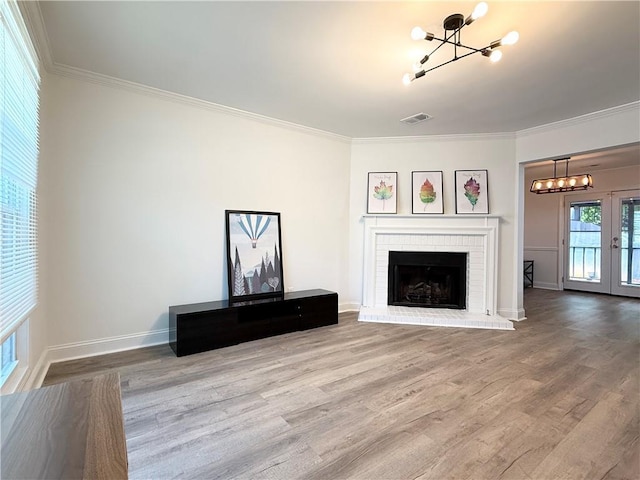 unfurnished living room with visible vents, ornamental molding, and an inviting chandelier