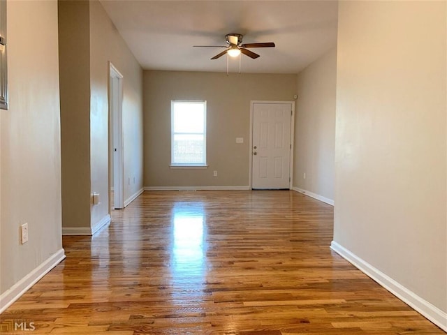 spare room with ceiling fan and light wood-type flooring