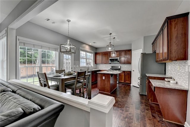 450 Hilingdon Way, Suwanee, GA 30024 - kitchen featuring stainless steel microwave, a center island, backsplash, dark wood-type flooring, and stove
