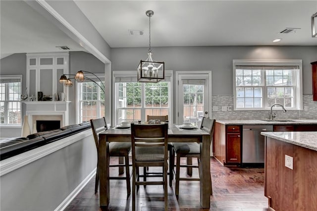 450 Hilingdon Way, Suwanee, GA 30024 - dining area featuring dark wood-style flooring, a chandelier, and healthy amount of natural light