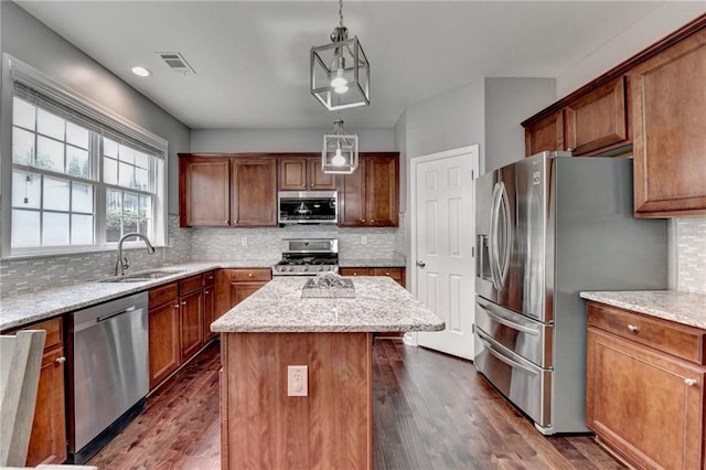 450 Hilingdon Way, Suwanee, GA 30024 - kitchen with appliances with stainless steel finishes, a sink, decorative backsplash, a center island, and light stone counters