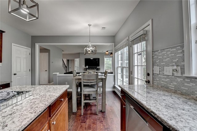 450 Hilingdon Way, Suwanee, GA 30024 - kitchen with stainless steel dishwasher, dark wood-style floors, light stone countertops, decorative backsplash, and hanging light fixtures