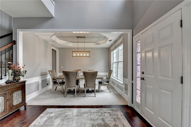 450 Hilingdon Way, Suwanee, GA 30024 - dining space with dark wood finished floors, a raised ceiling, and a chandelier