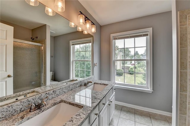 450 Hilingdon Way, Suwanee, GA 30024 - bathroom with baseboards, double vanity, a stall shower, tile patterned flooring, and toilet