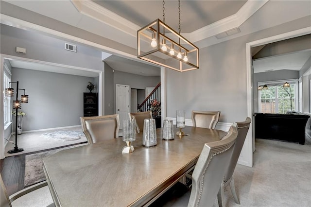 450 Hilingdon Way, Suwanee, GA 30024 - dining space with a chandelier, stairs, light carpet, and a raised ceiling