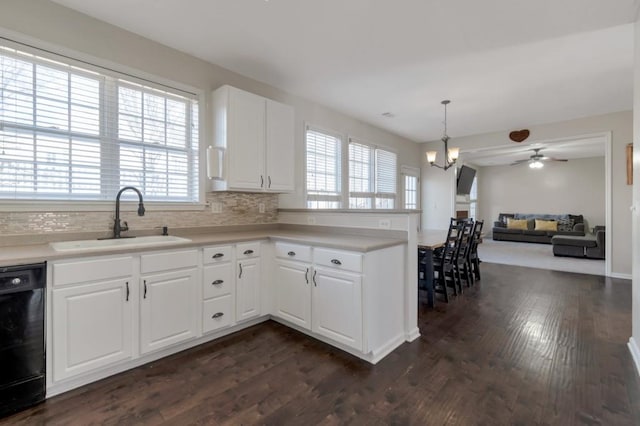 kitchen with white cabinetry, sink, hanging light fixtures, and dishwasher