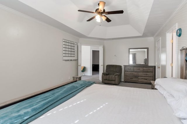 carpeted bedroom featuring ceiling fan, ornamental molding, and a raised ceiling