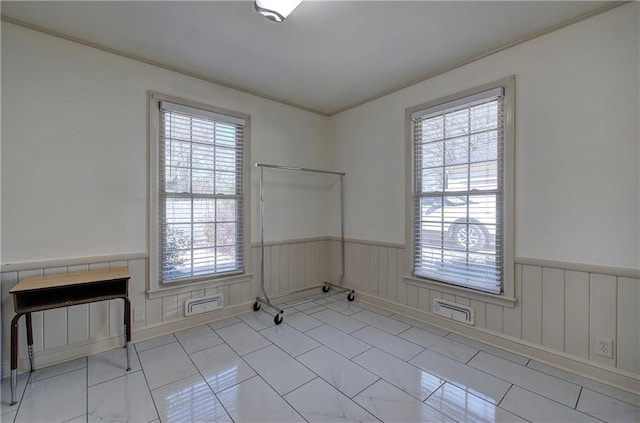 empty room featuring wainscoting