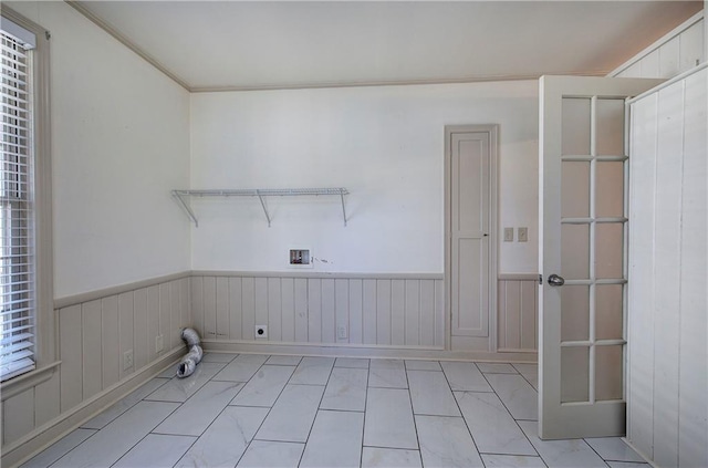 laundry area featuring laundry area, hookup for an electric dryer, washer hookup, and a wainscoted wall