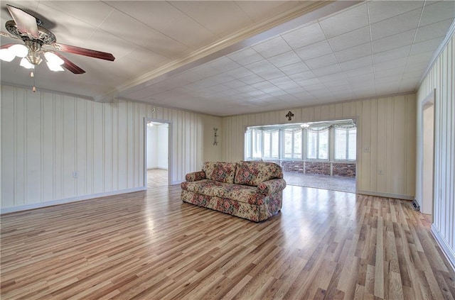 living room featuring baseboards, a ceiling fan, and wood finished floors