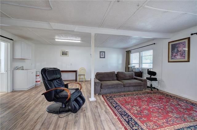 living area featuring baseboards and light wood-style floors