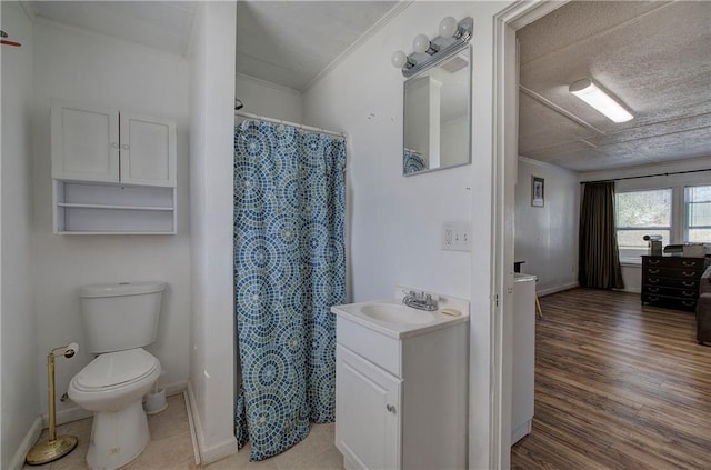 full bath featuring toilet, wood finished floors, baseboards, and ornamental molding