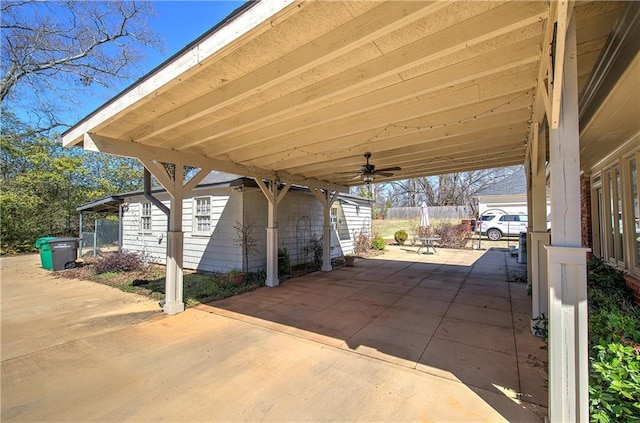 view of patio / terrace with a carport and fence