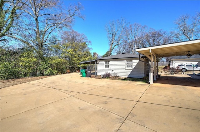 view of patio with a carport and driveway